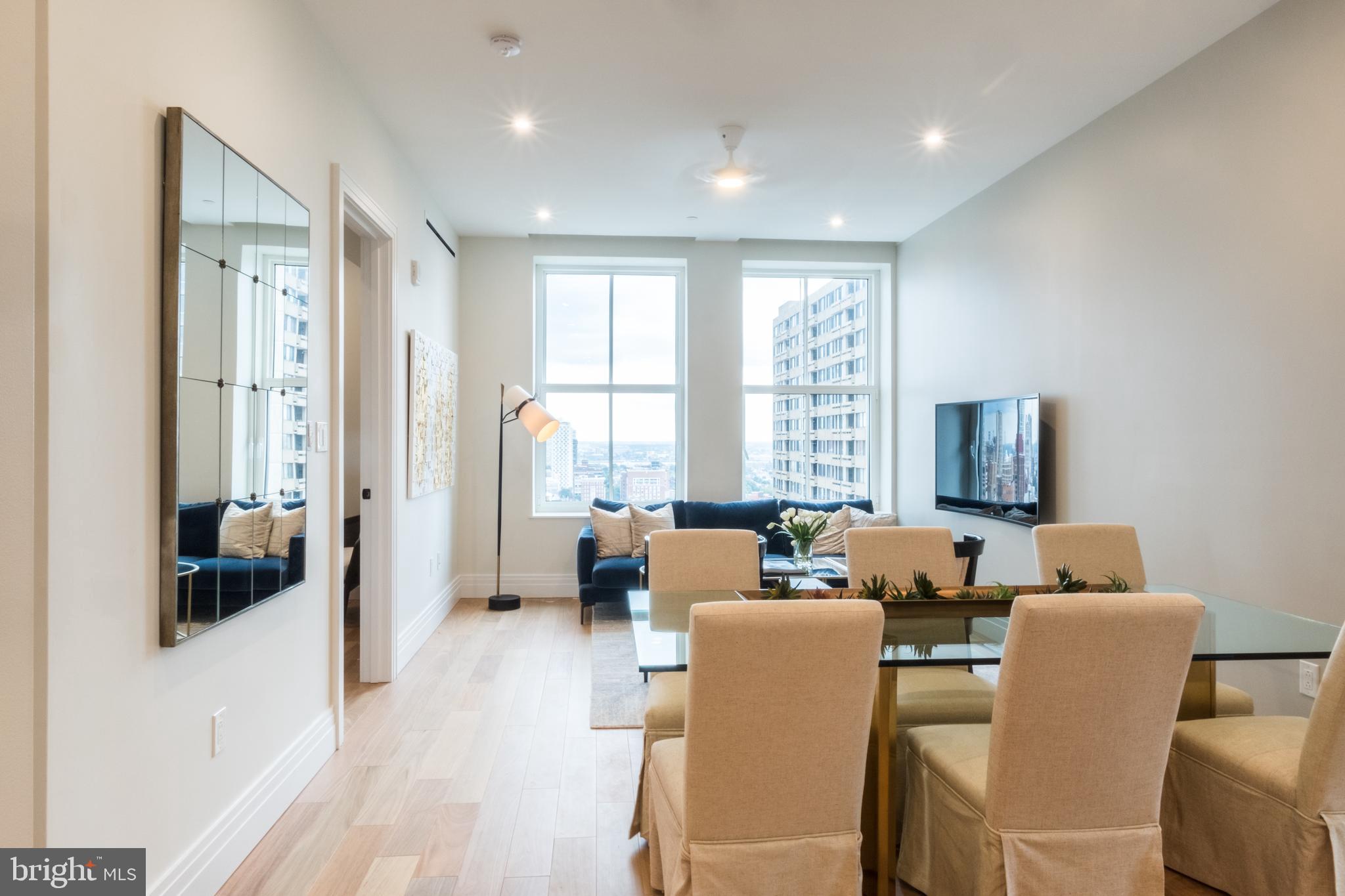 1401 Spruce Street, Unit 3BED B Philadelphia, PA 19102 - Photo 3 of 13 a living room with furniture and large windows