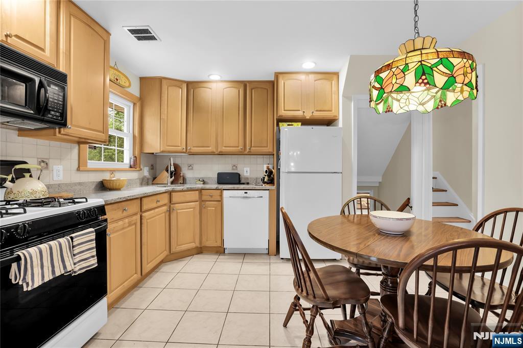 23 Ridge Court Cedar Grove, NJ 07009 - Photo 15 of 37 a kitchen with a table and chairs in it