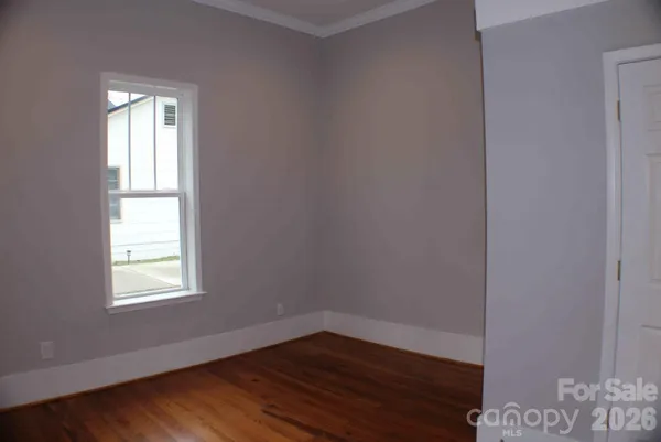 a view of a room with wooden floor