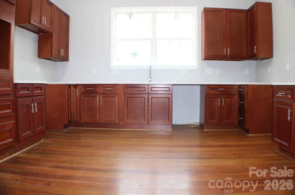 a view of a kitchen with wooden floor and cabinet