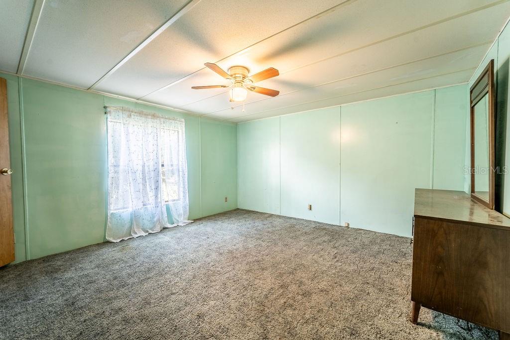 24031 Armadillo Road Astor, FL 32102 - Photo 33 of 43 an empty room with windows and fan