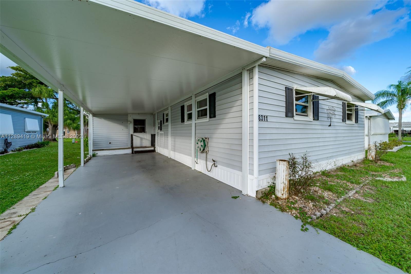 8311 South Street Boca Raton, FL 33433 - Photo 11 of 40 a view of a house with a street