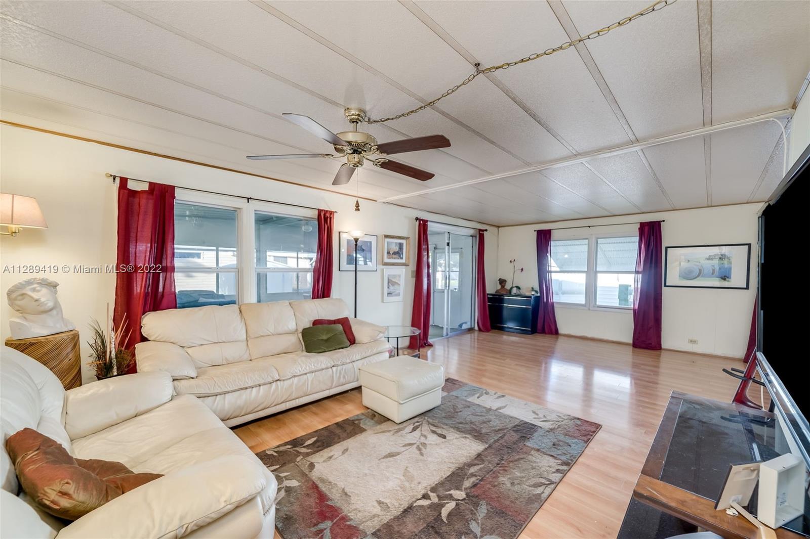 8311 South Street Boca Raton, FL 33433 - Photo 3 of 40 a living room with furniture and wooden floor
