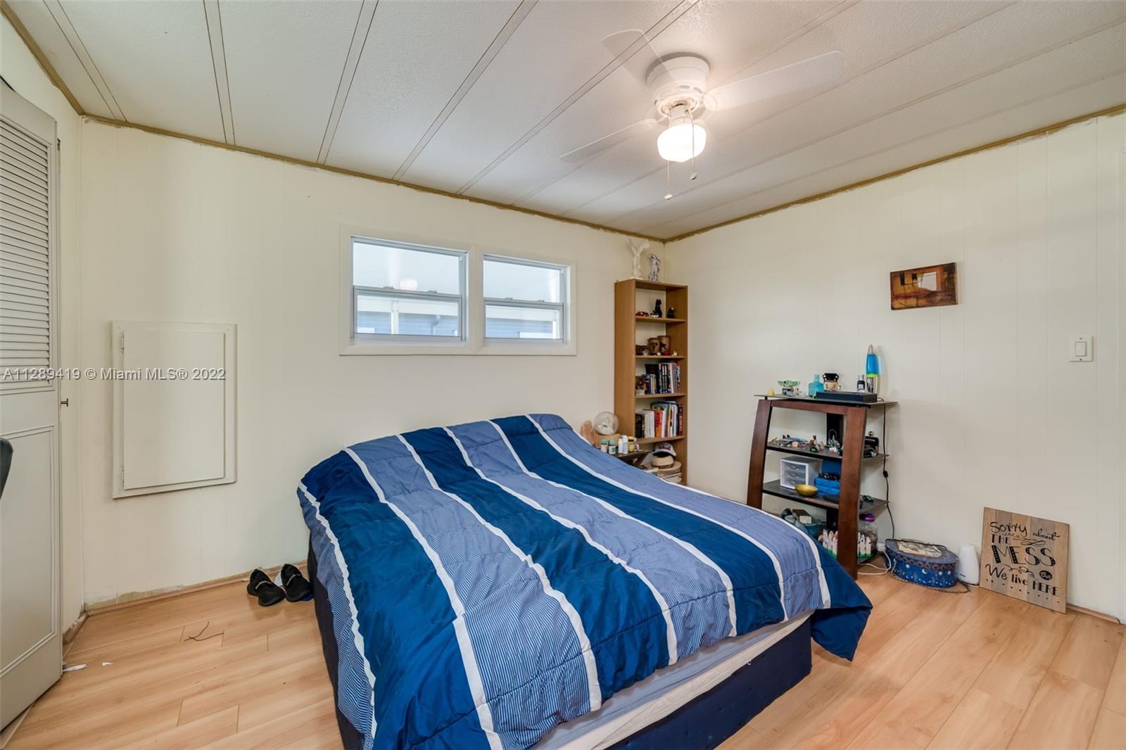 8311 South Street Boca Raton, FL 33433 - Photo 8 of 40 a bedroom with a bed and a chandelier