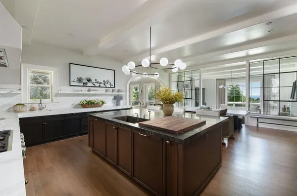 a kitchen with granite countertop a sink stove and wooden floor