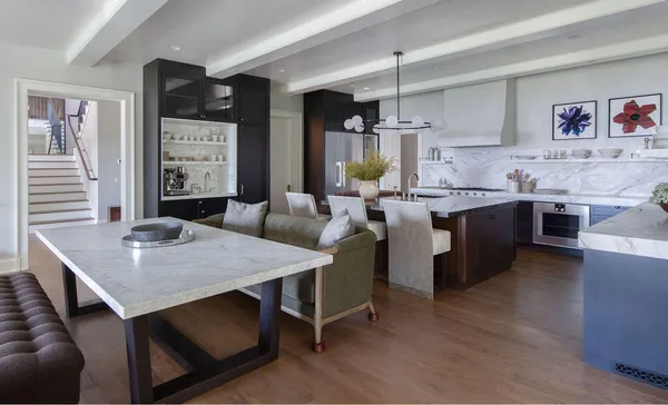 a kitchen with a table chairs sink and cabinets