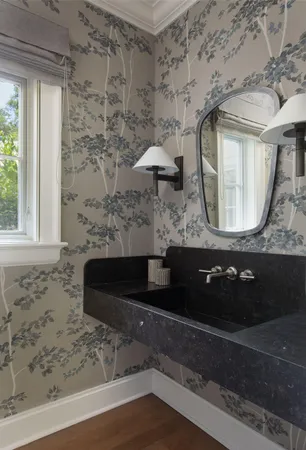 a bathroom with a granite countertop sink a mirror and bathtub