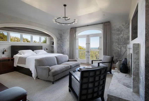 a bedroom with a bed and a chandelier