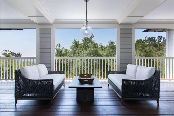a living room with furniture a window and wooden floor