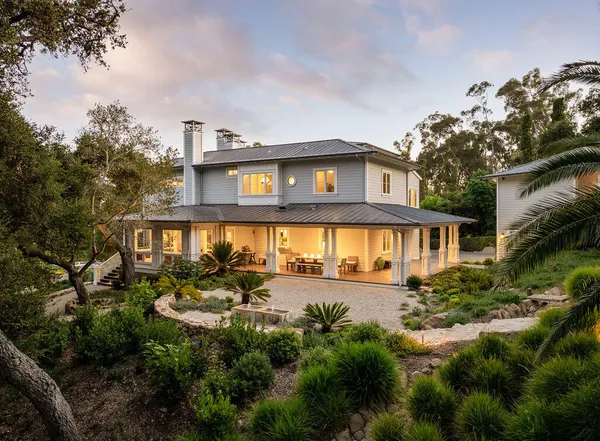a view of a house with a small yard and plants