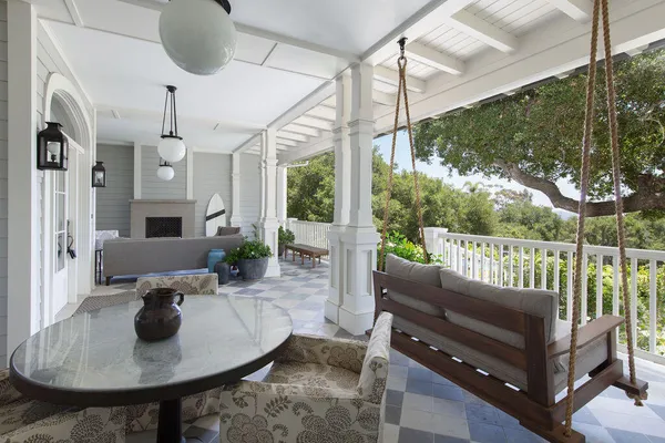 a living room with furniture a chandelier and a fireplace