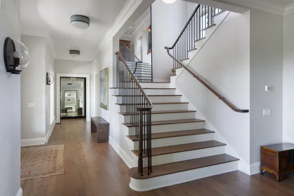 a view of entryway and hall with wooden floor