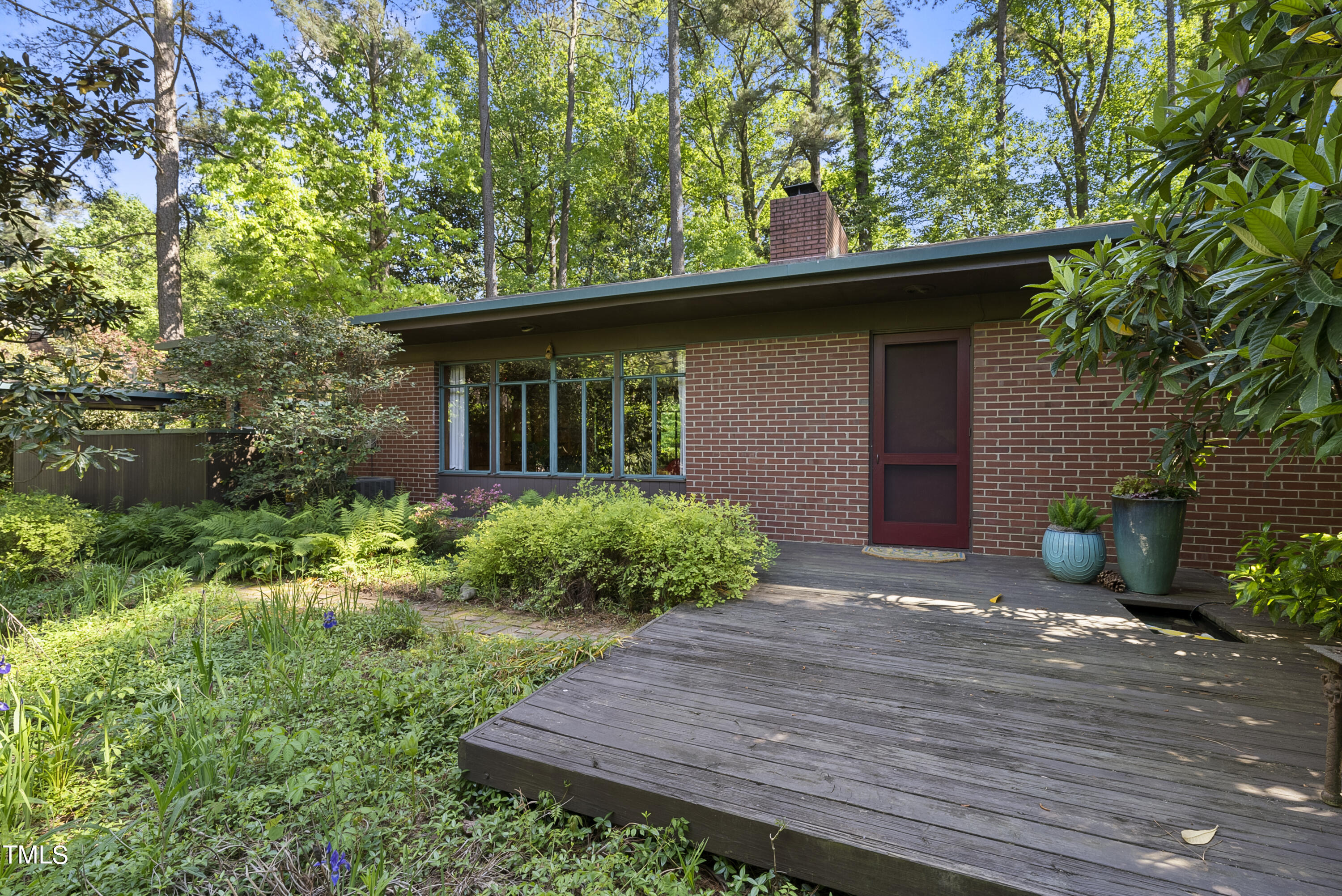 2715 Rosedale Avenue Raleigh, NC 27607 - Photo 22 of 46 Exterior Front: Walk into a garden entry courtyard to access the front door. A front deck has a small koi pond!