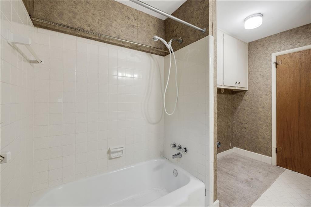 1911 Alderbrook Road Northeast Atlanta, GA 30345 - Photo 23 of 33 a bathroom with a bathtub and a shower