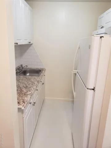 a bathroom with a granite countertop shower and a sink