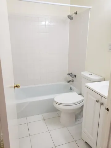 a bathroom with a toilet sink and shower
