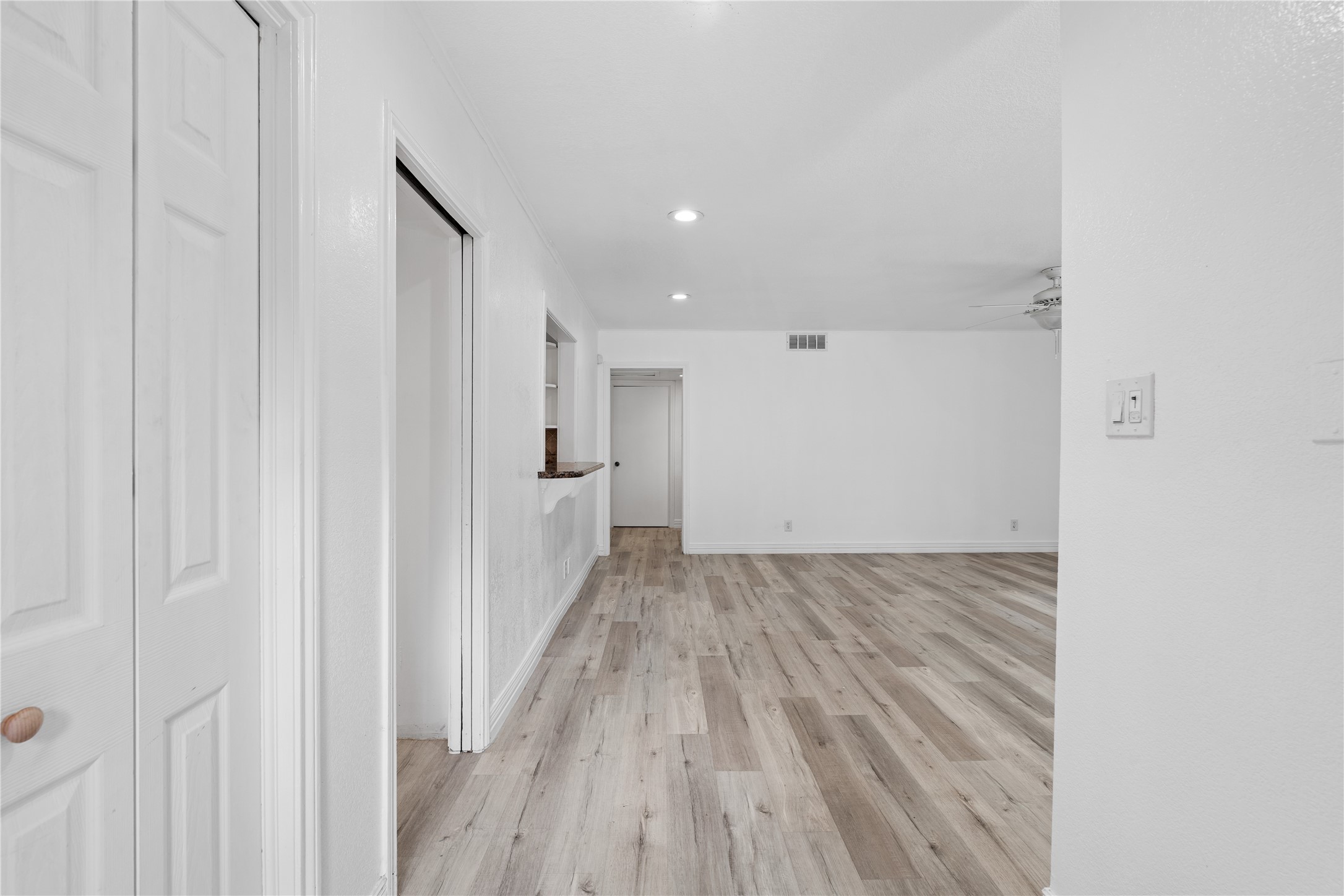 6303 Crab Orchard Road, Unit 3 Houston, TX 77057 - Photo 3 of 30 As you cross the threshold, you are immediately struck by the wide-plank luxury flooring that stretches throughout the open-concept layout. The fresh, gallery-white walls and recessed LED lighting create a bright, airy atmosphere, while the pass-through breakfast bar hints at the seamless flow into the kitchen.