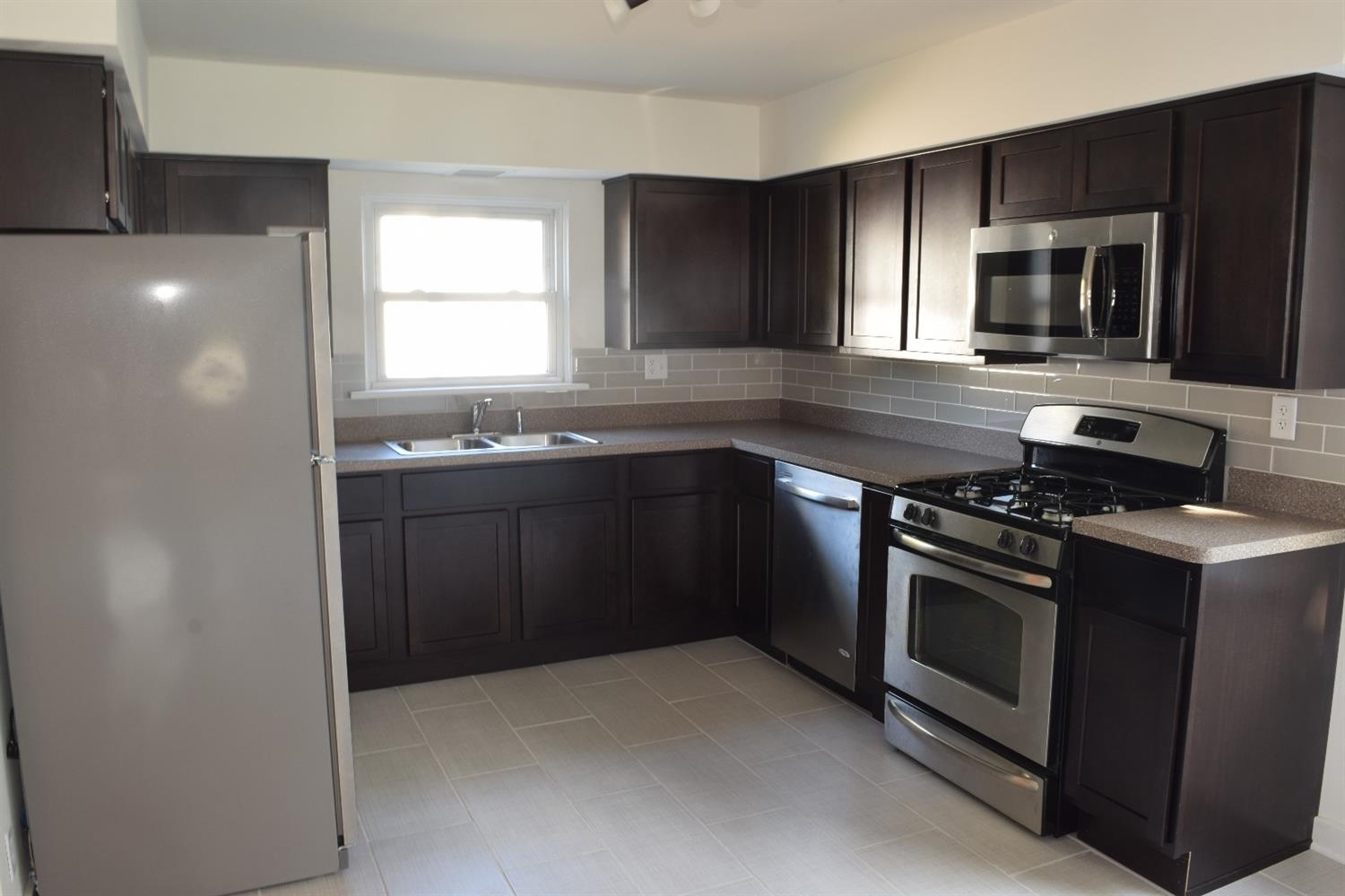 3245 Ridge Road Highland, IN 46322 - Photo 5 of 10 a kitchen with stainless steel appliances a sink stove and microwave