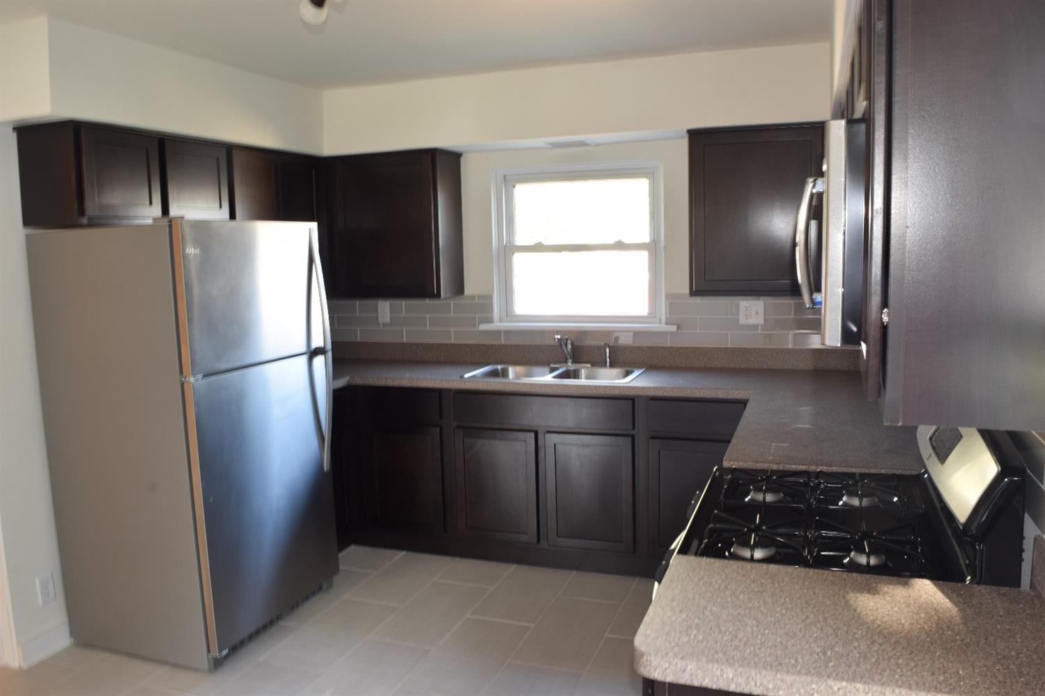 3245 Ridge Road Highland, IN 46322 - Photo 7 of 10 a kitchen with a sink and a refrigerator
