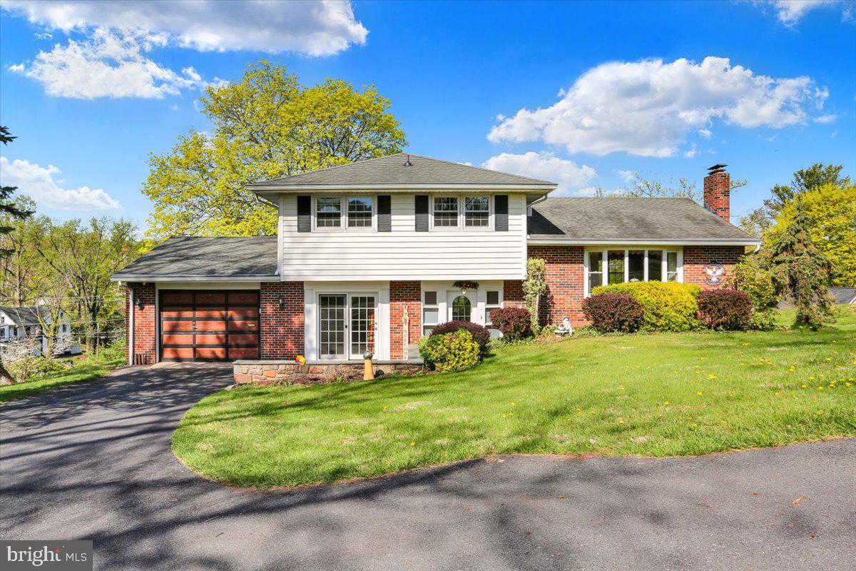 324 Ashley Drive Reading, PA 19607 - Photo 1 of 39 a front view of a house with a yard table and chairs