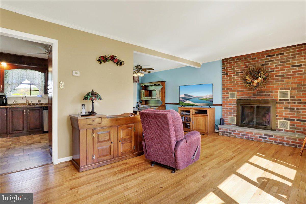 324 Ashley Drive Reading, PA 19607 - Photo 13 of 39 a living room with furniture a fireplace and kitchen view