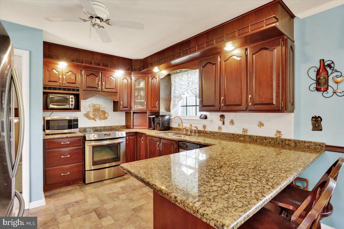 324 Ashley Drive Reading, PA 19607 - Photo 18 of 39 a kitchen with stainless steel appliances granite countertop a sink stove and refrigerator