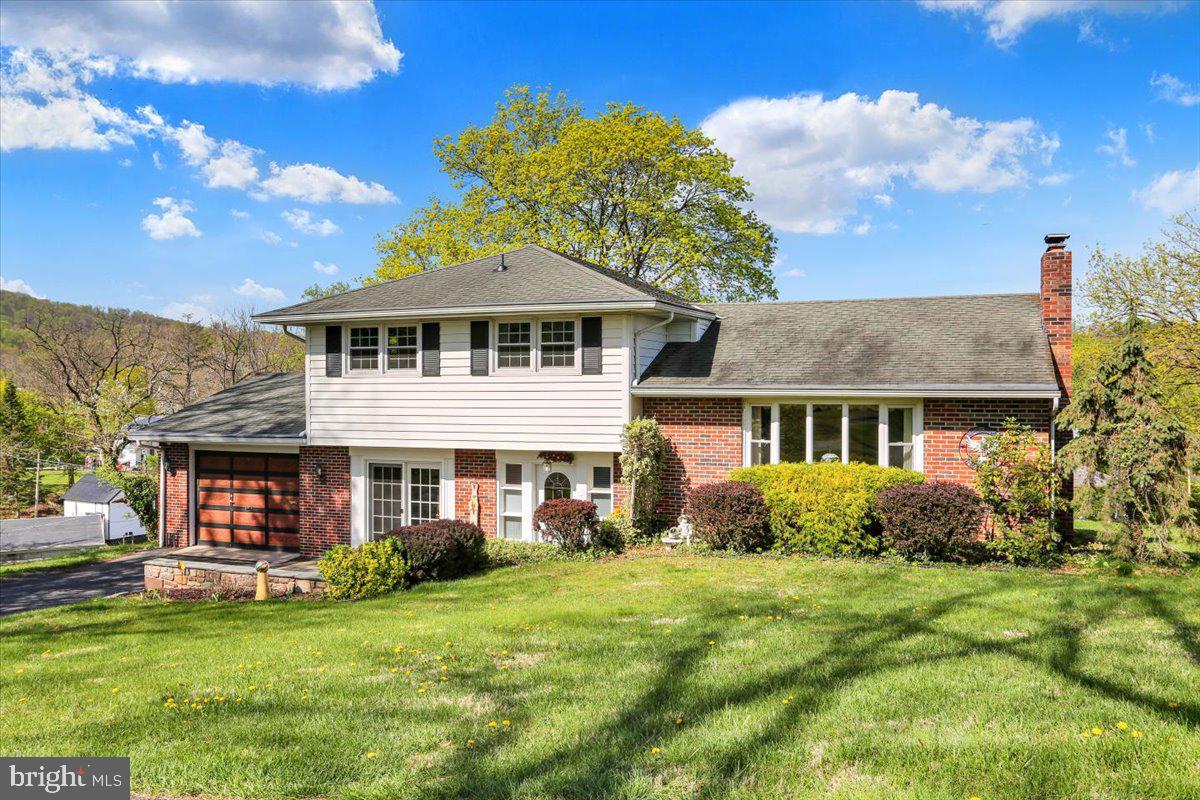 324 Ashley Drive Reading, PA 19607 - Photo 2 of 39 a front view of a house with a garden