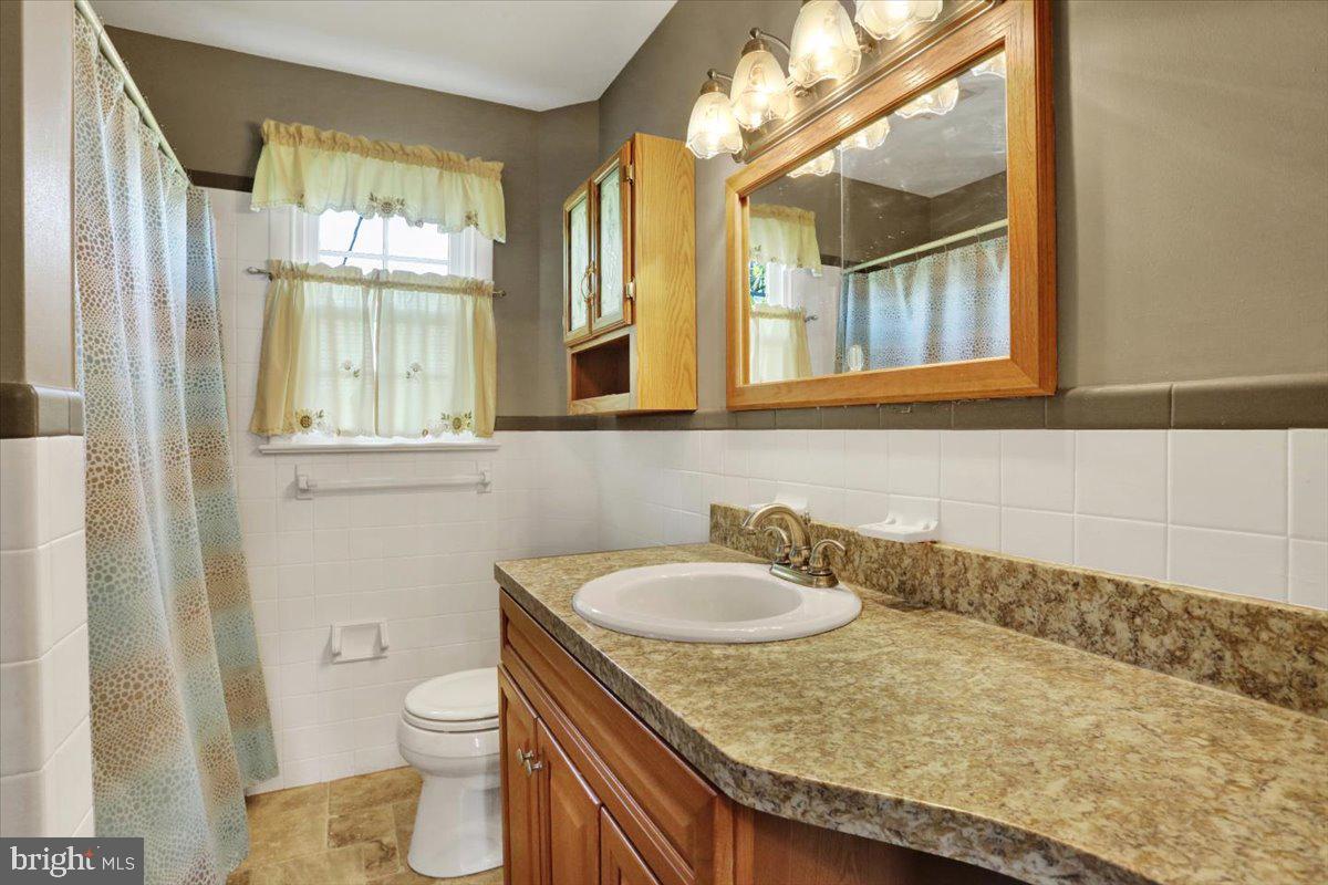 324 Ashley Drive Reading, PA 19607 - Photo 25 of 39 a bathroom with a granite countertop sink and a mirror