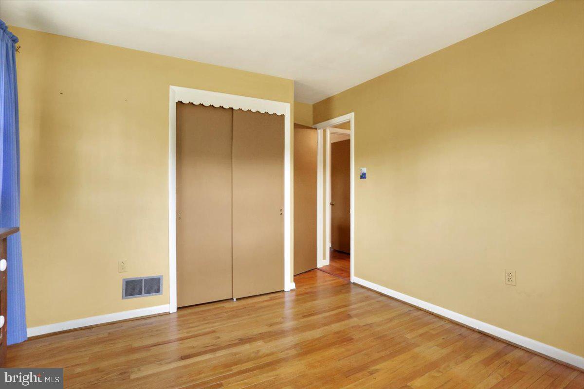 324 Ashley Drive Reading, PA 19607 - Photo 28 of 39 a view of an empty room with wooden floor and a window