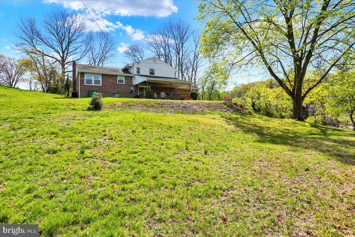 324 Ashley Drive Reading, PA 19607 - Photo 37 of 39 a view of a yard with plants and large trees