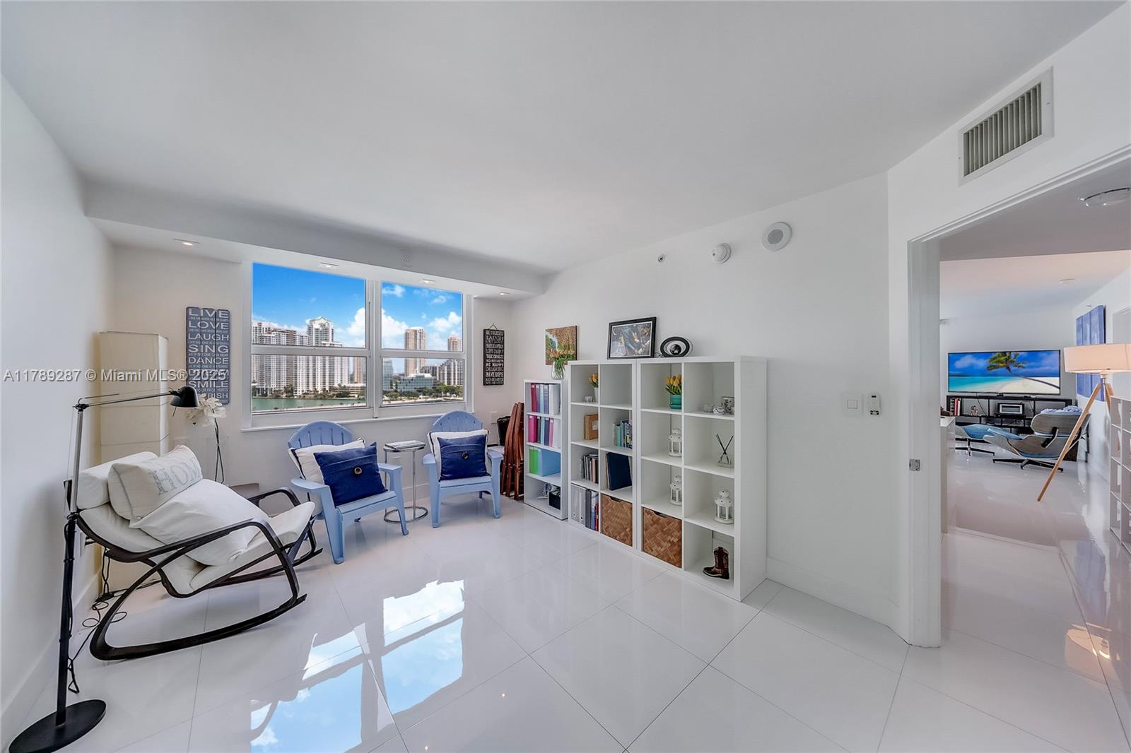 1155 Brickell Bay Drive, Unit 1210 Miami, FL 33131 - Photo 11 of 18 a living room with furniture and a kitchen
