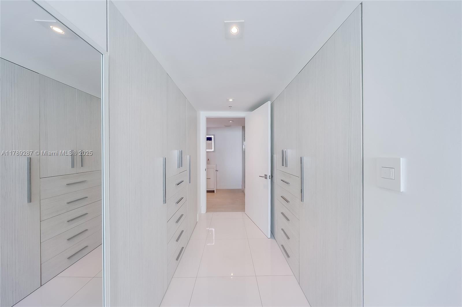 1155 Brickell Bay Drive, Unit 1210 Miami, FL 33131 - Photo 12 of 18 a spacious bathroom with a glass shower door and a shower