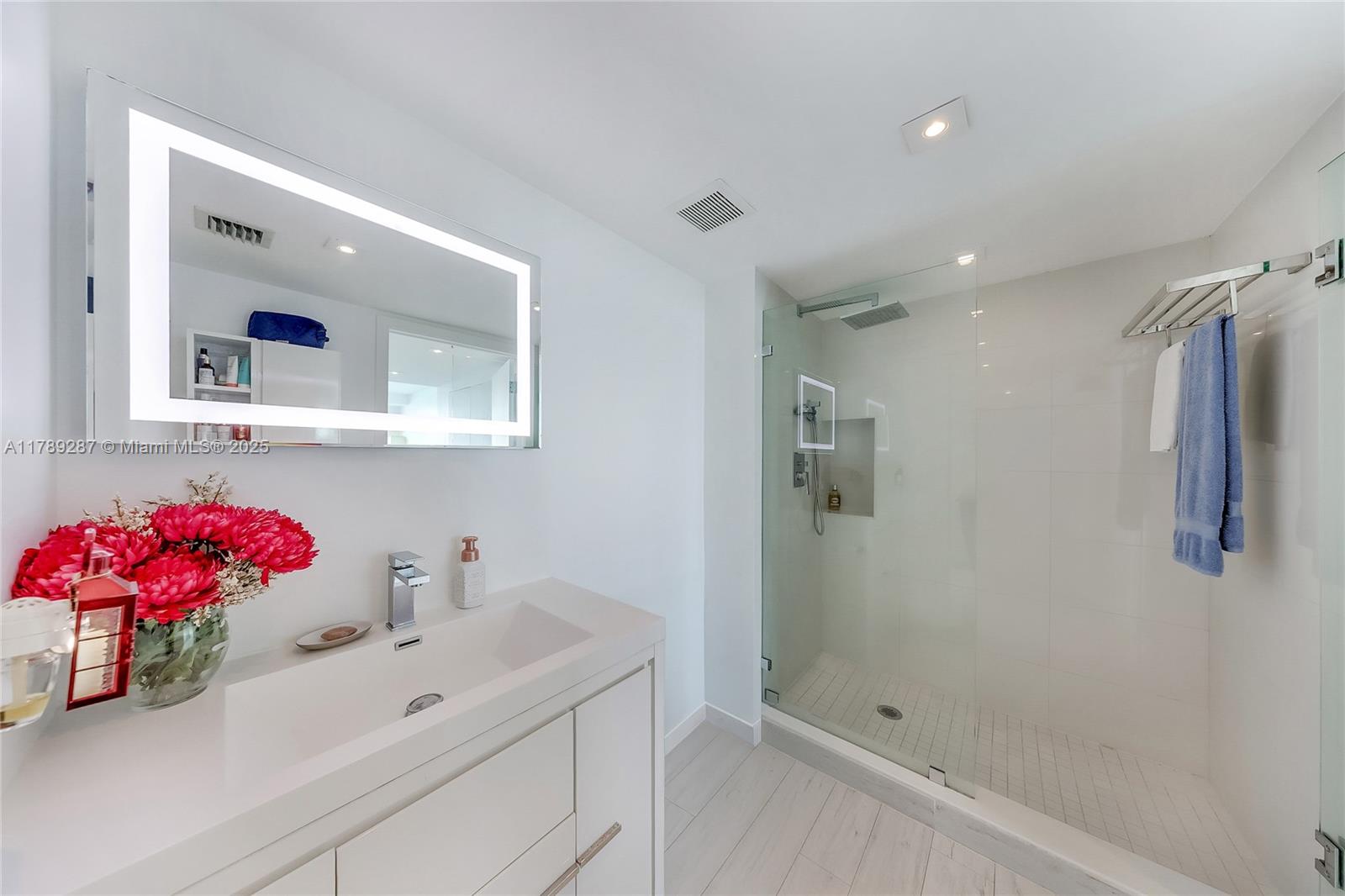 1155 Brickell Bay Drive, Unit 1210 Miami, FL 33131 - Photo 13 of 18 a bathroom with a sink vanity tub and shower
