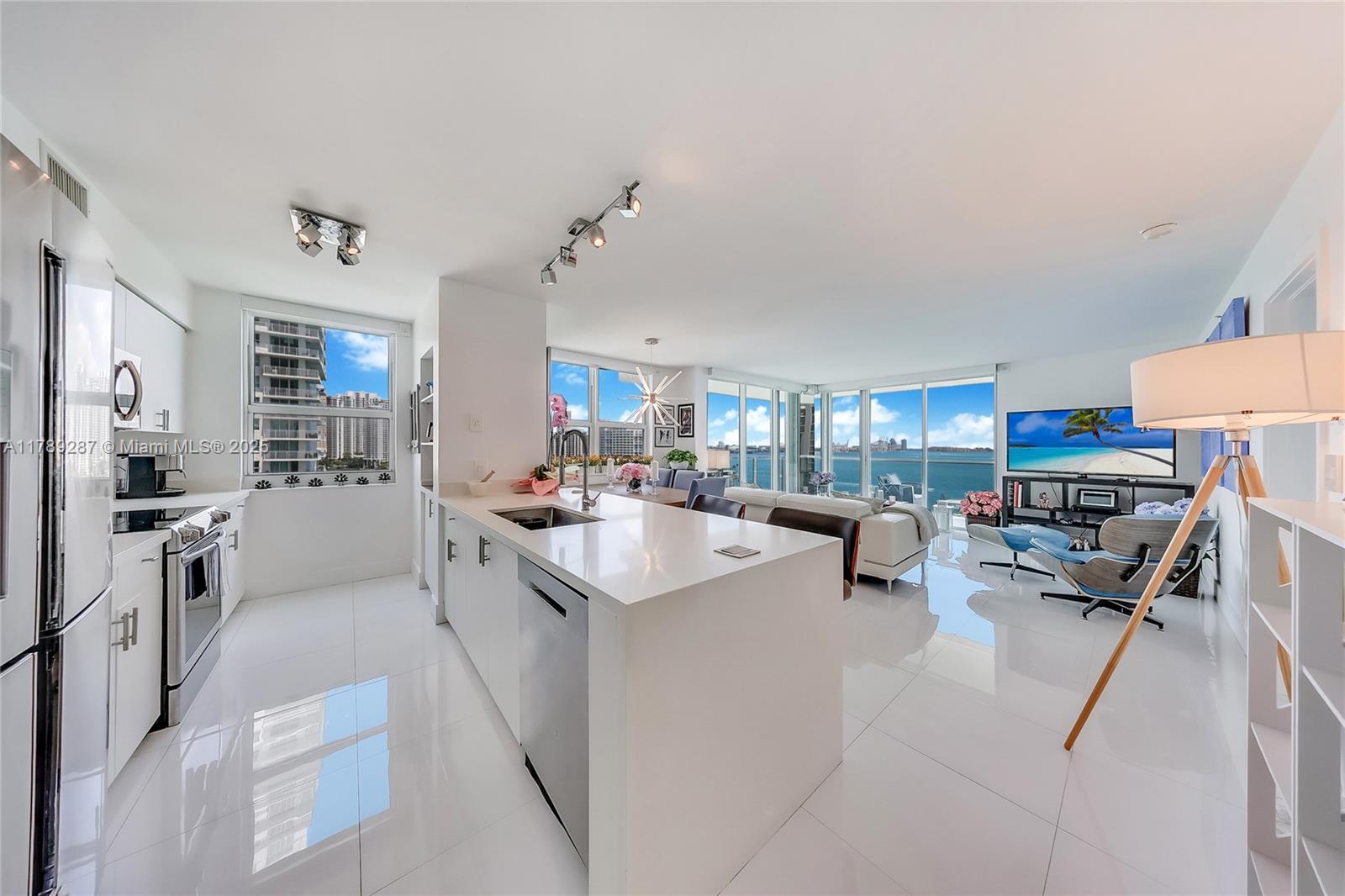 1155 Brickell Bay Drive, Unit 1210 Miami, FL 33131 - Photo 2 of 18 a kitchen with sink refrigerator and stove
