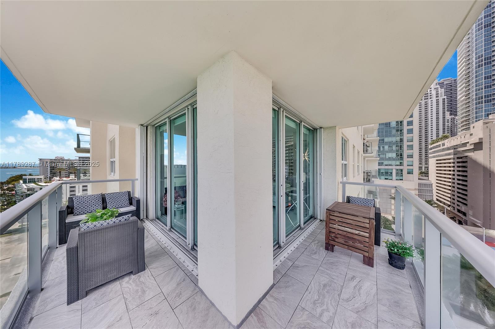 1155 Brickell Bay Drive, Unit 1210 Miami, FL 33131 - Photo 3 of 18 a room with patio furniture and a kitchen view