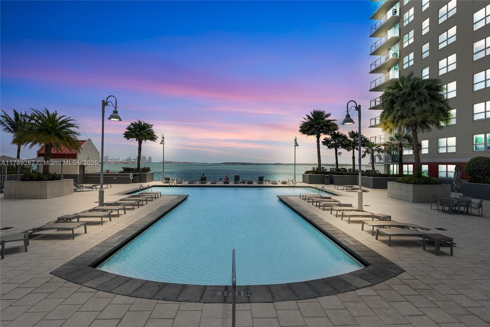 1155 Brickell Bay Drive, Unit 1210 Miami, FL 33131 - Photo 9 of 18 a view of a swimming pool with outdoor seating