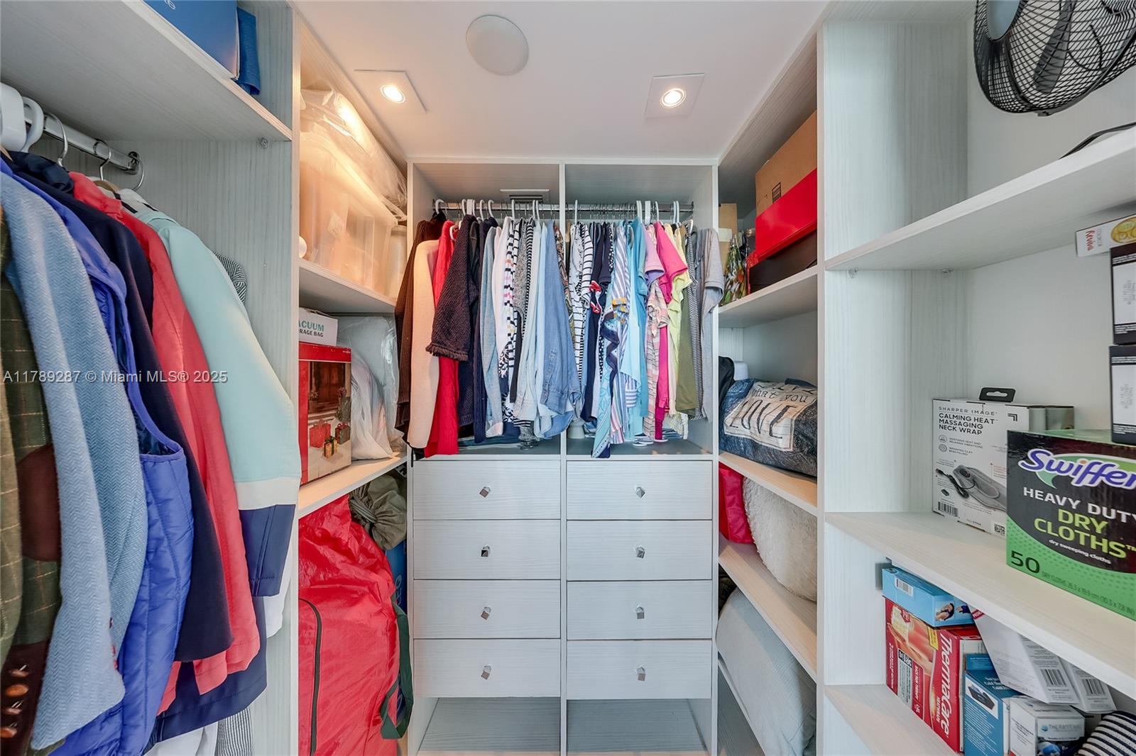 1155 Brickell Bay Drive, Unit 1210 Miami, FL 33131 - Photo 10 of 18 a view of walk in closet with clothes and shoes