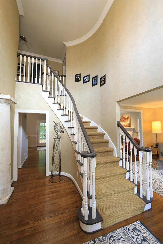 7812 Mayapple Place Raleigh, NC 27613 - Photo 3 of 30 If you didn't feel the good vibes when you drove by, you will get the idea once you step inside! Foyer and Staircase