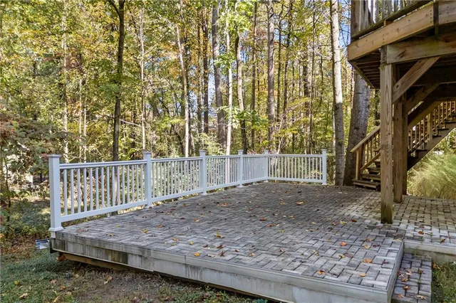 a view of a dining room with furniture a chandelier and wooden floor