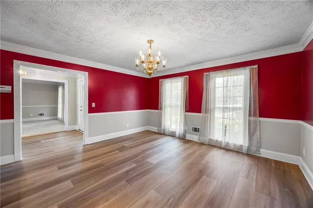 an empty room with fireplace and fan