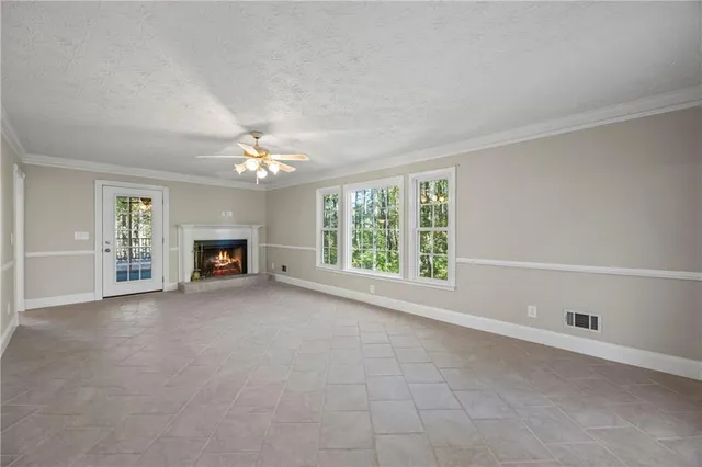 a view of wooden floor and windows in a room