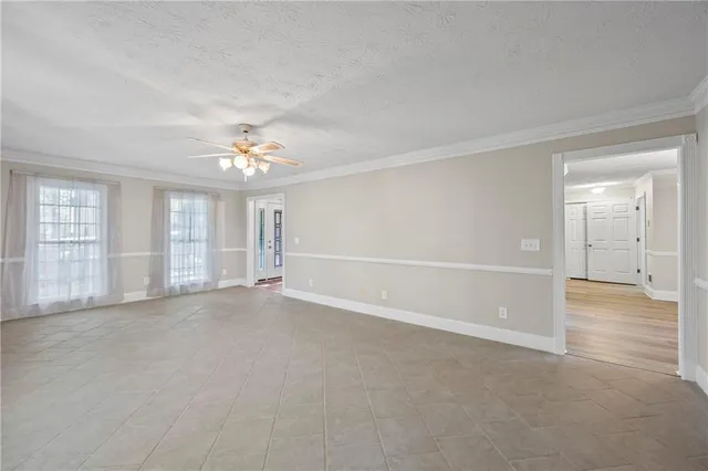 a view of an empty room with wooden floor and balcony