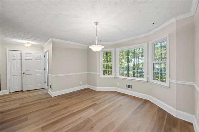 a view of a house with a large window and wooden fence