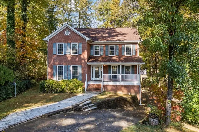 a front view of a house with a yard table and chairs