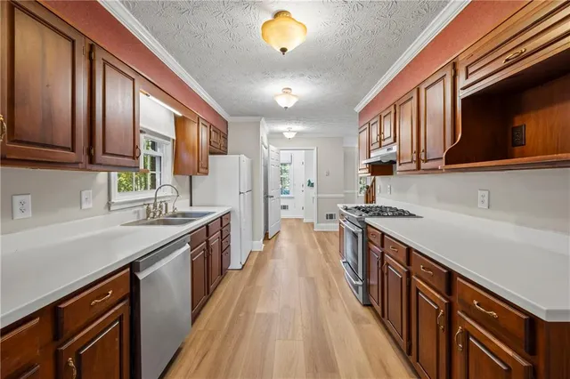 a bathroom with a sink toilet and a mirror