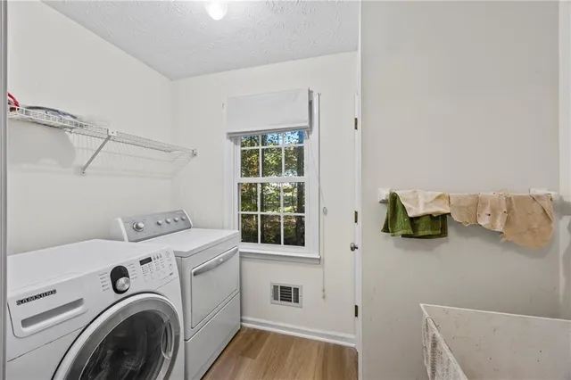 a bedroom with a bed and a dresser next to a window