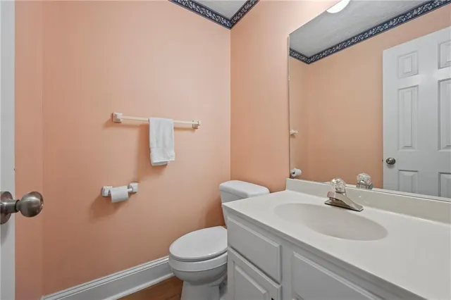 a bathroom with a sink a toilet a window and a shower