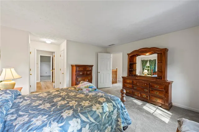 a bedroom with a bed a couch and a window