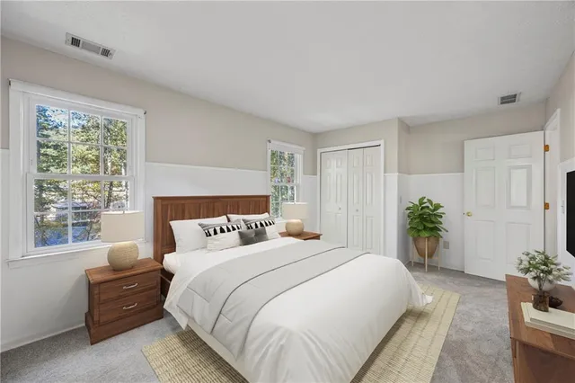 a bedroom with a large bed and a chandelier