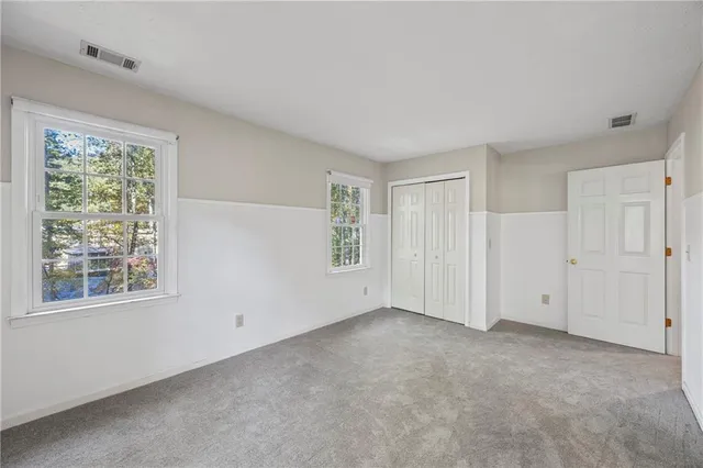 a bedroom with a bed table and window